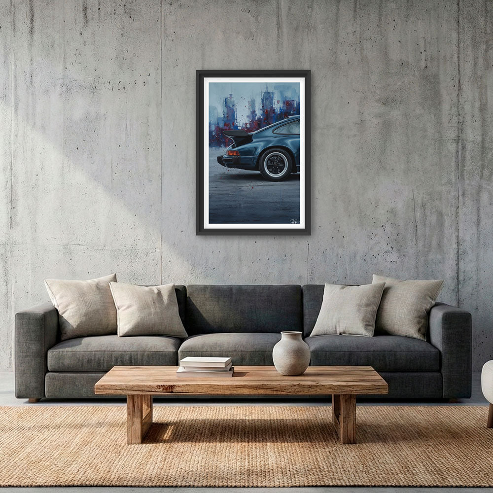 Living room with a gray sofa, wooden coffee table, and framed artwork of a car on a concrete wall.
