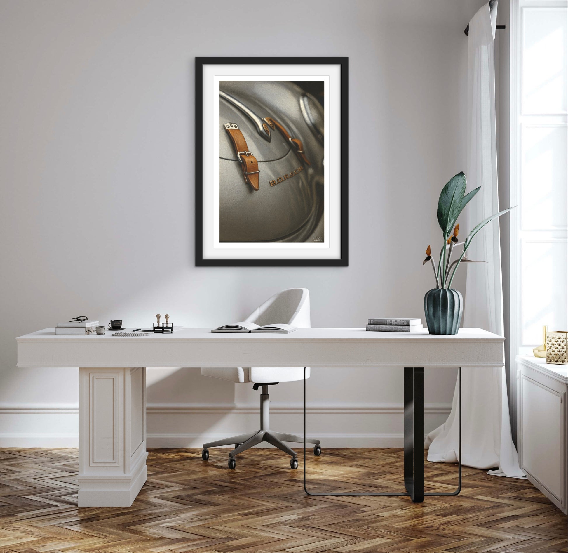 Modern office setup with a white desk, chair, and framed artwork on a light gray wall.