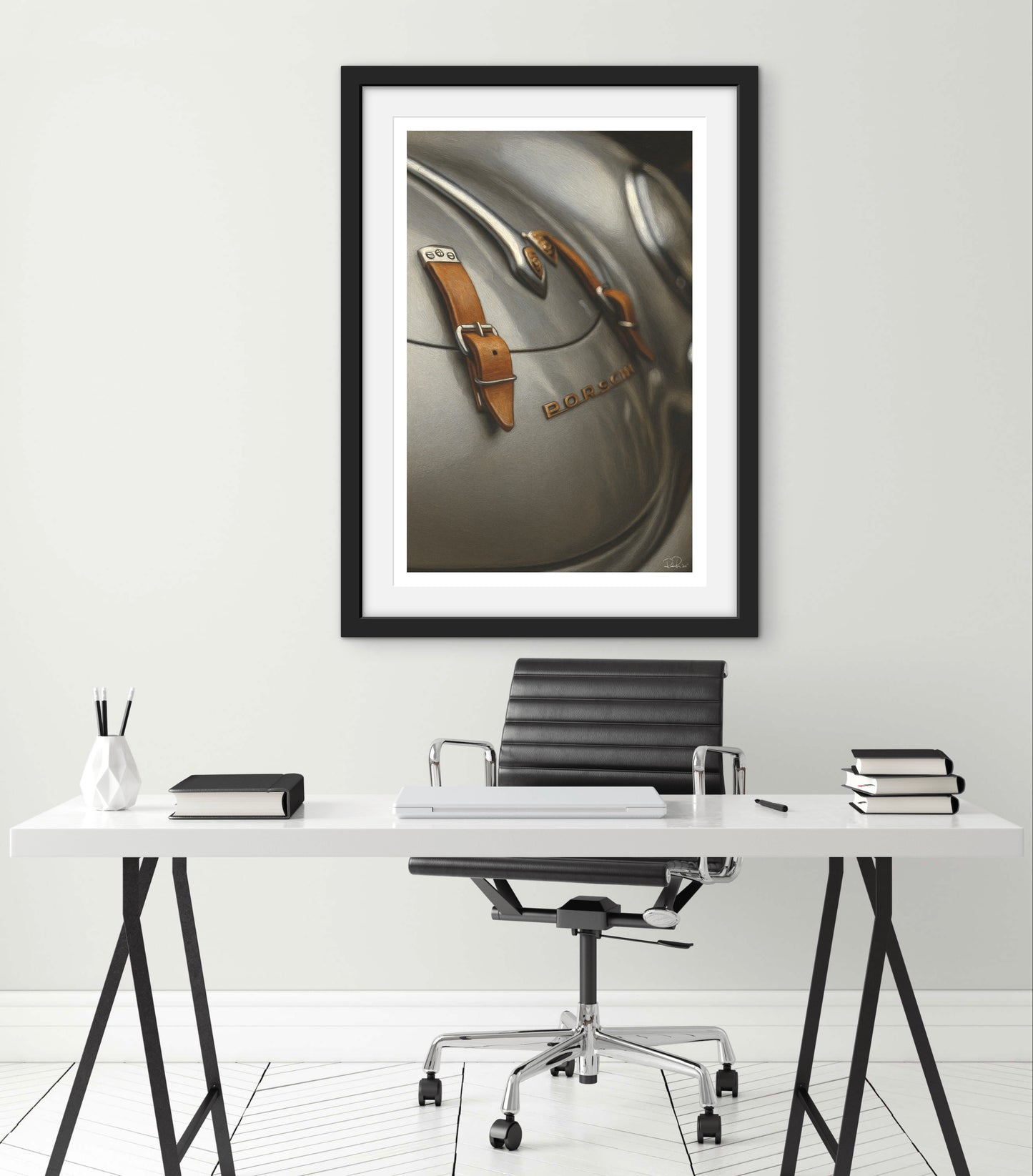 Framed artwork of a car dashboard on a wall above a desk with office furniture.