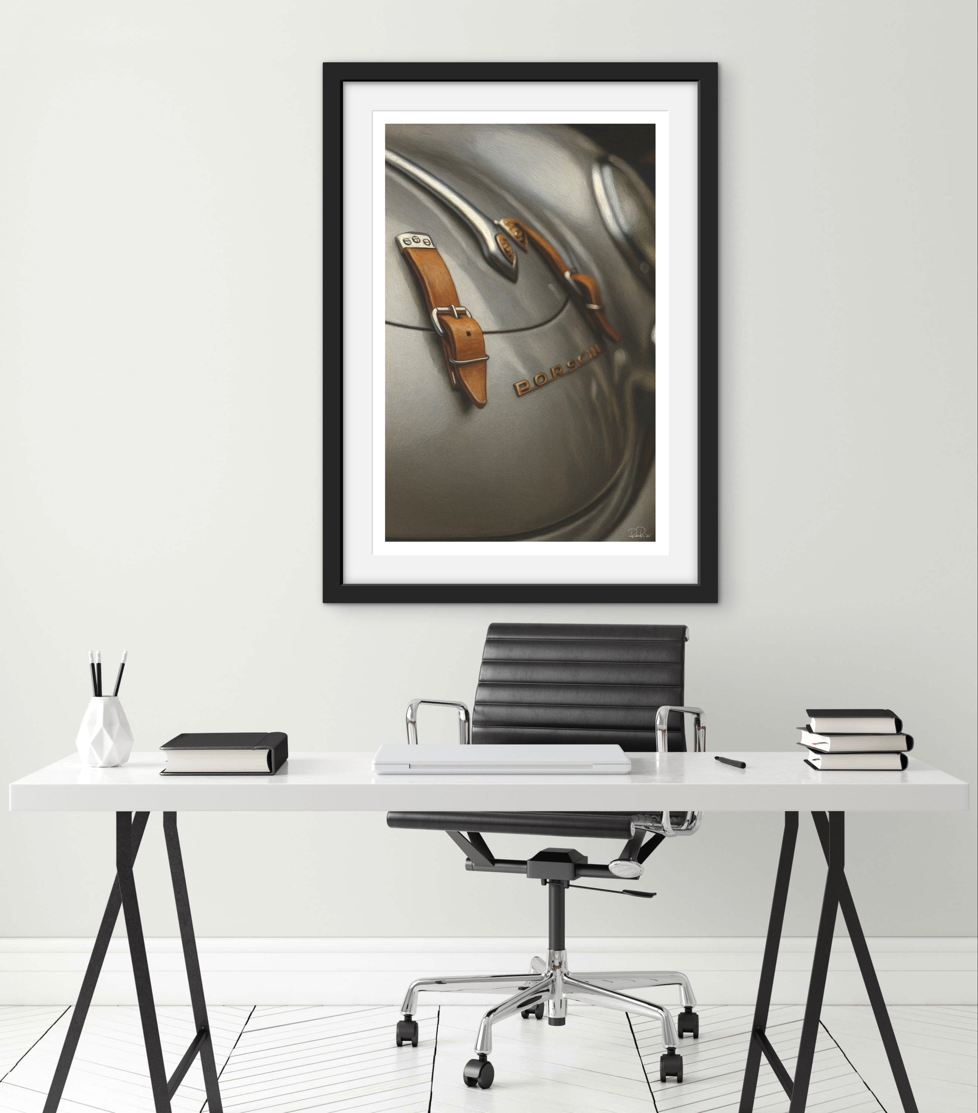 Framed artwork of a car dashboard on a wall above a desk with office furniture.