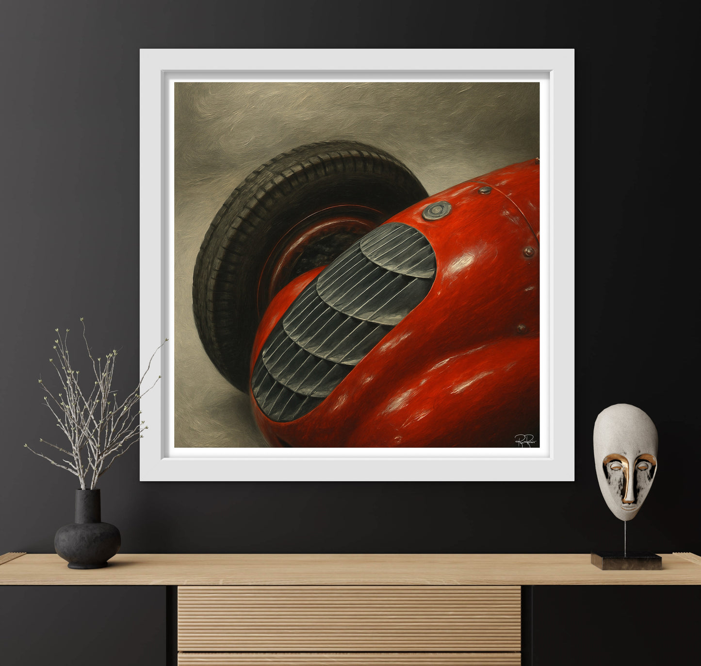 Framed artwork of a red vintage car on a dark wall with decorative items below.