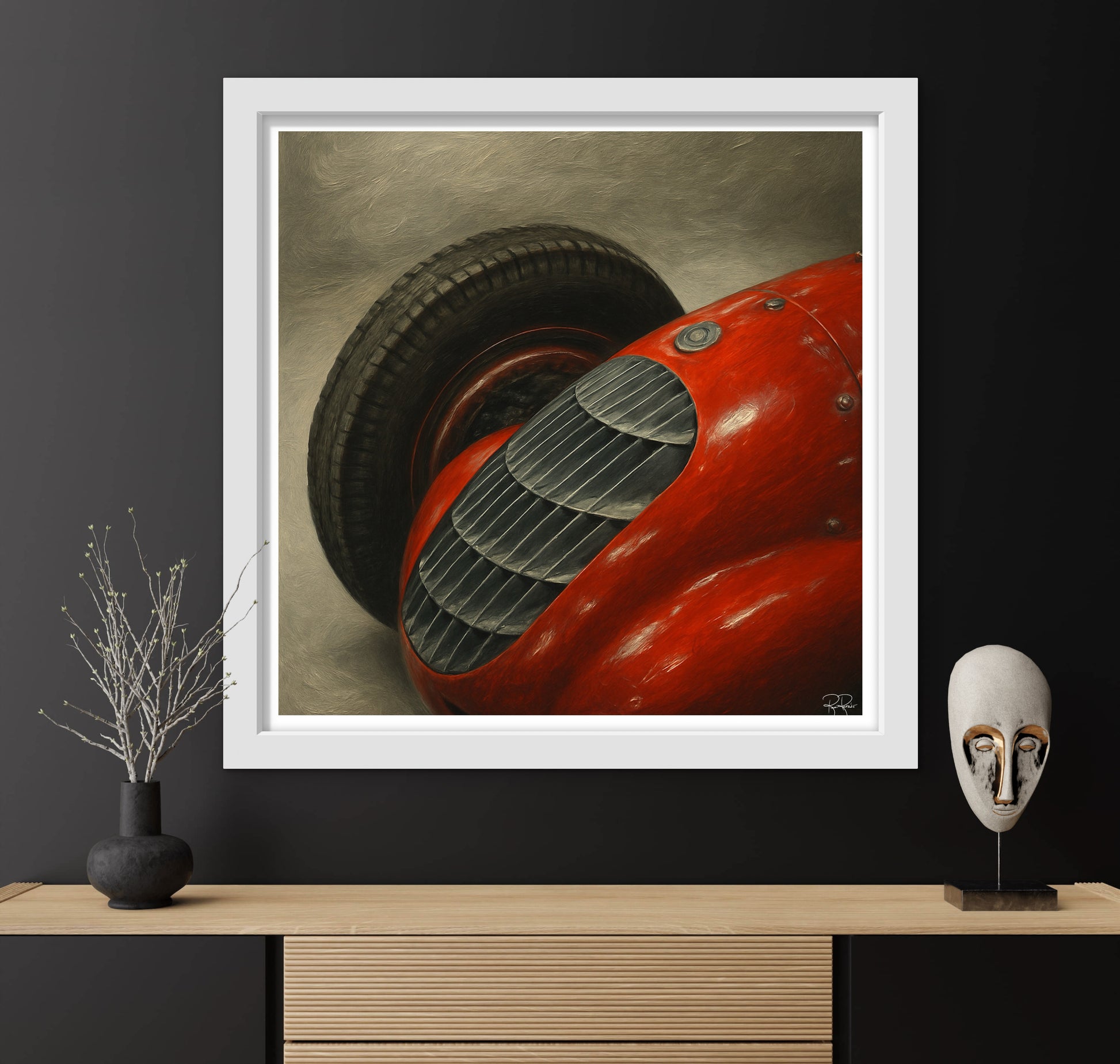 Framed artwork of a red vintage car on a dark wall with decorative items below.