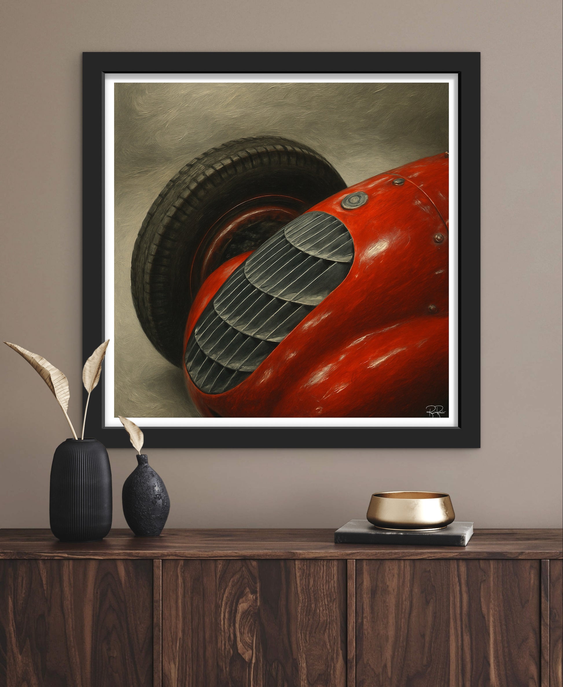 Framed artwork of a red car on a wooden shelf with decorative items.