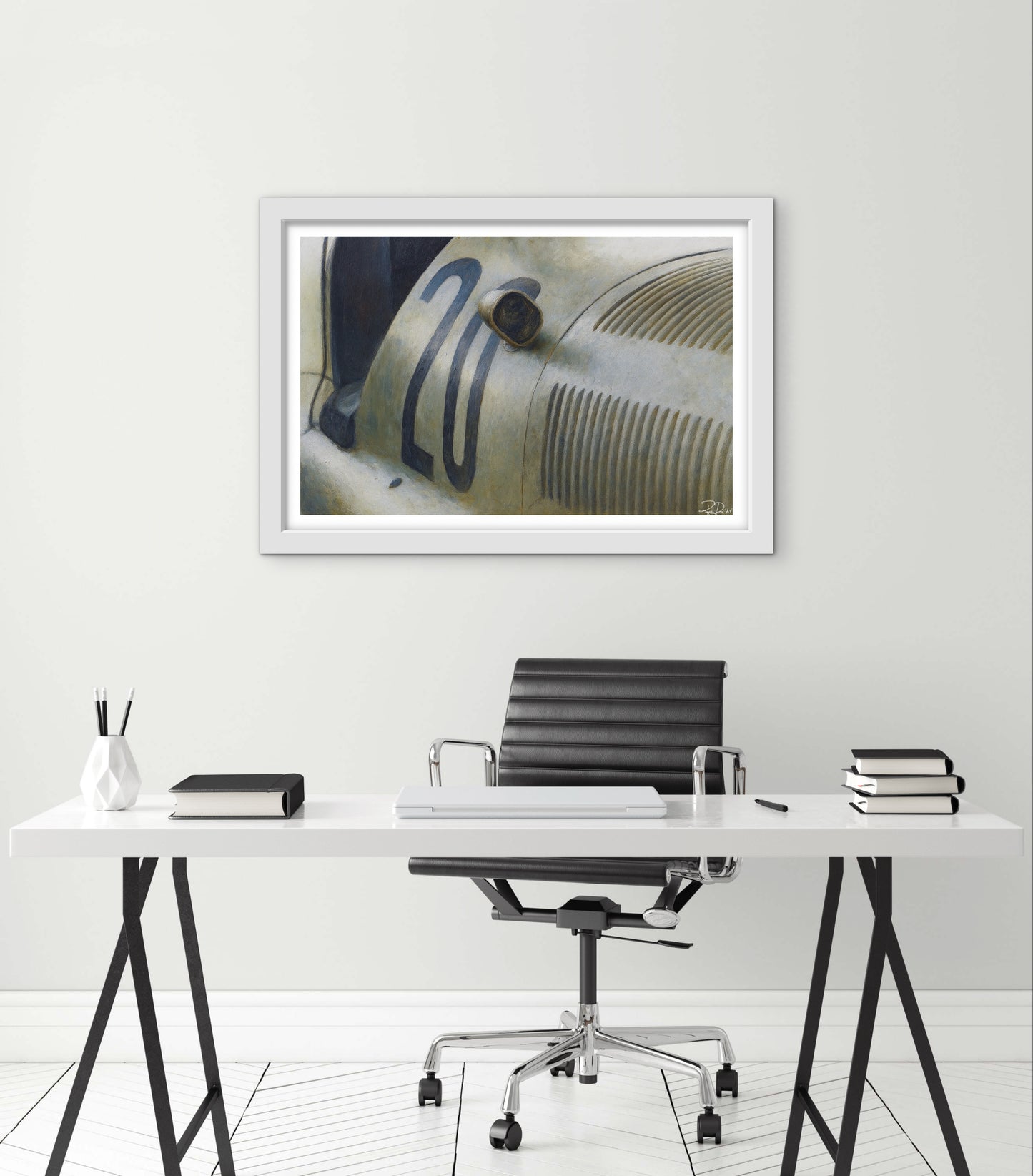 Modern office setup with a desk, chair, and framed picture on the wall.