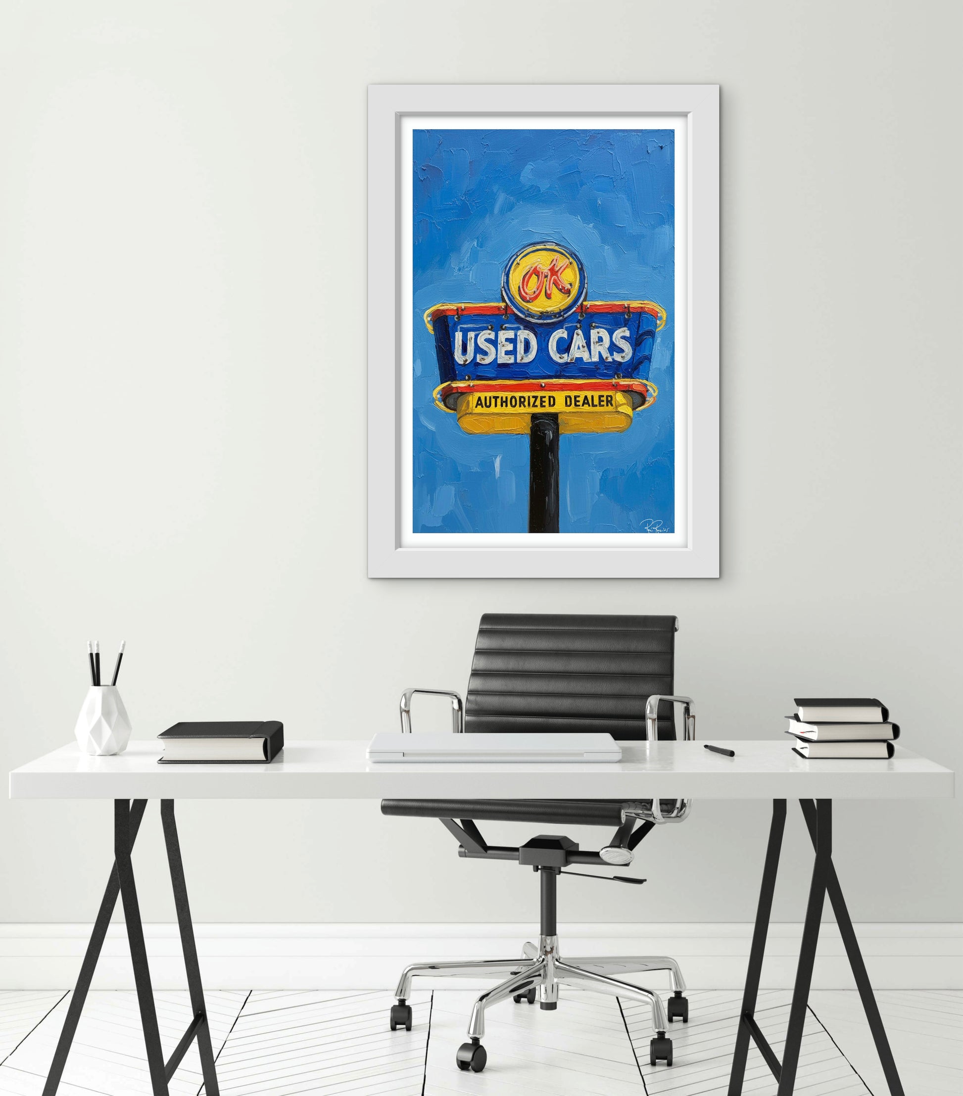 Framed OK Used Cars sign above a desk with office chair