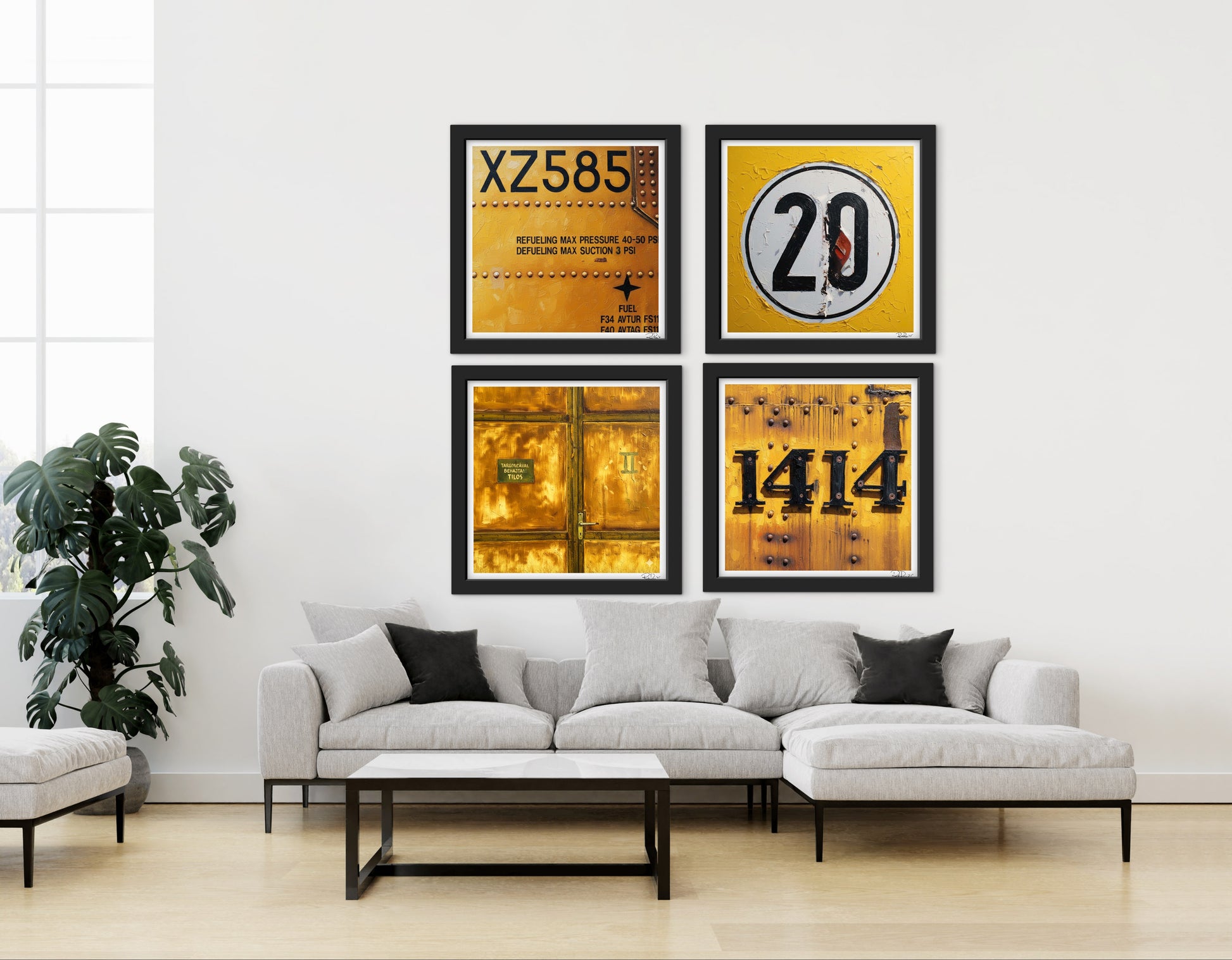 Four framed posters on a wall above a sofa in a living room.