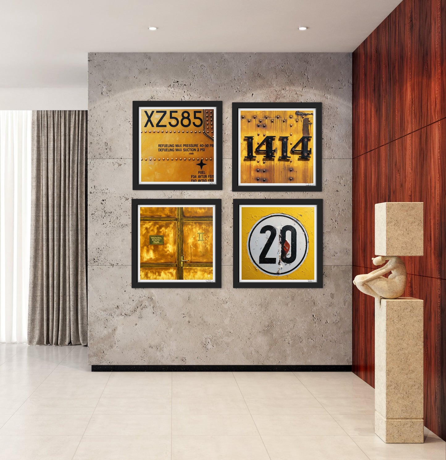 Four framed posters on a concrete wall with a modern interior setting.