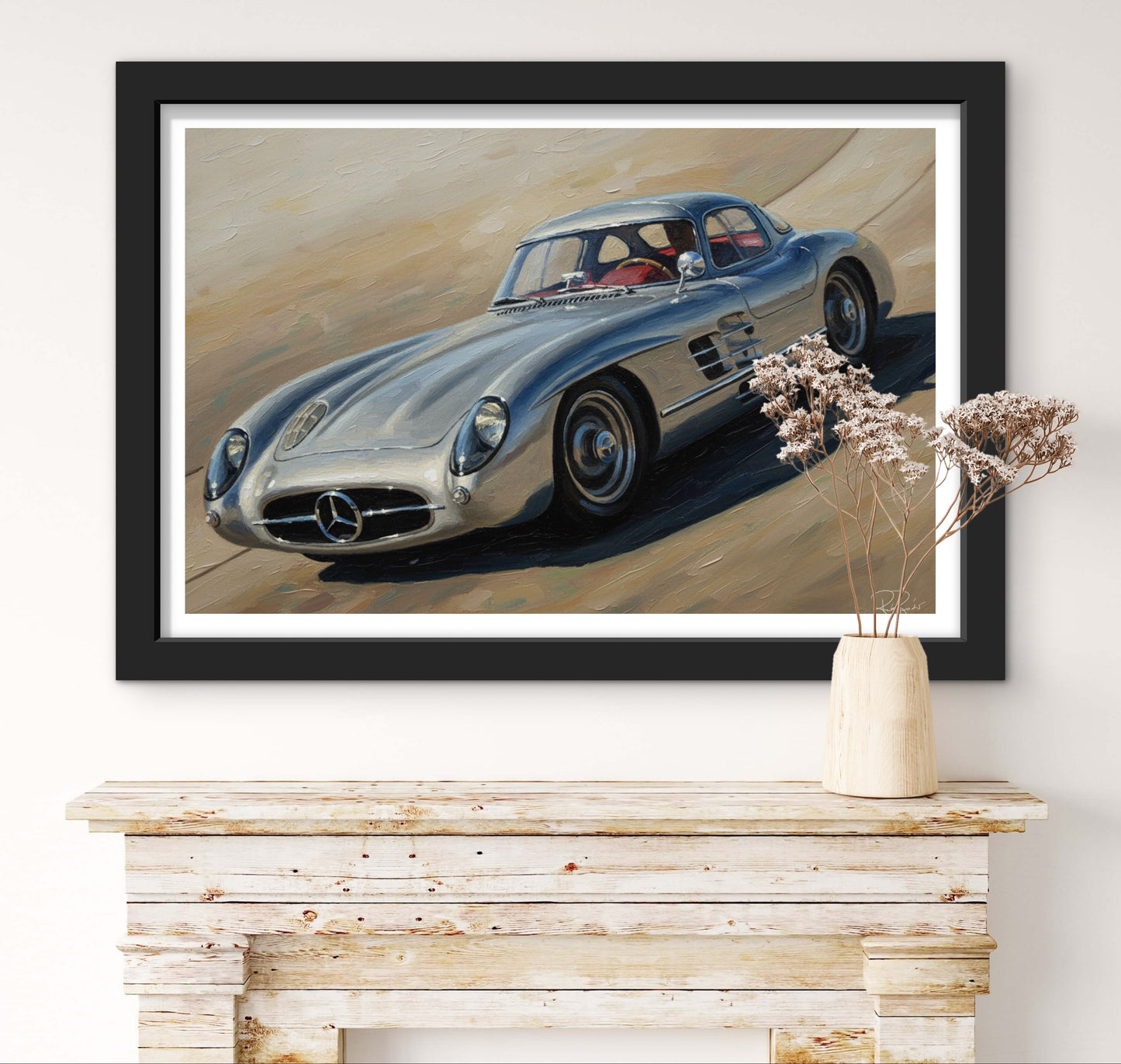 Framed artwork of a classic Mercedes-Benz car on a wall above a wooden console table.