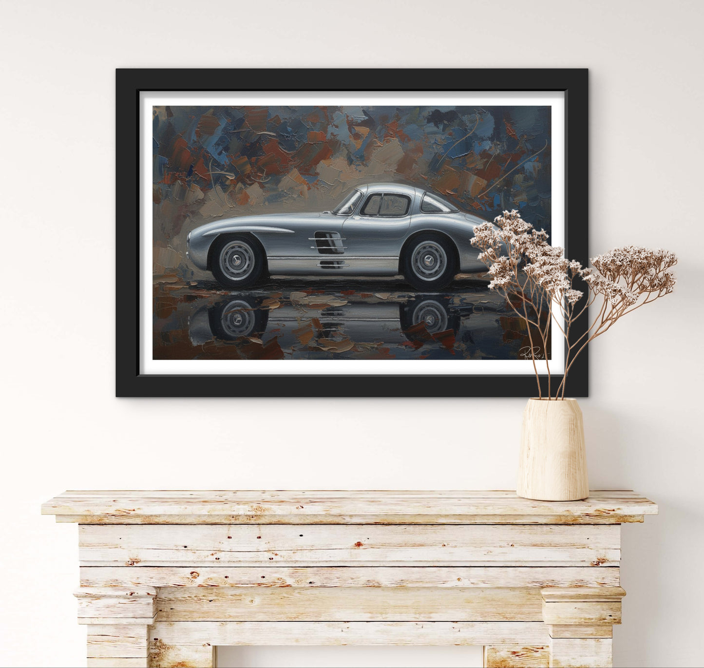 Framed painting of a silver vintage car on a wall above a wooden console table.