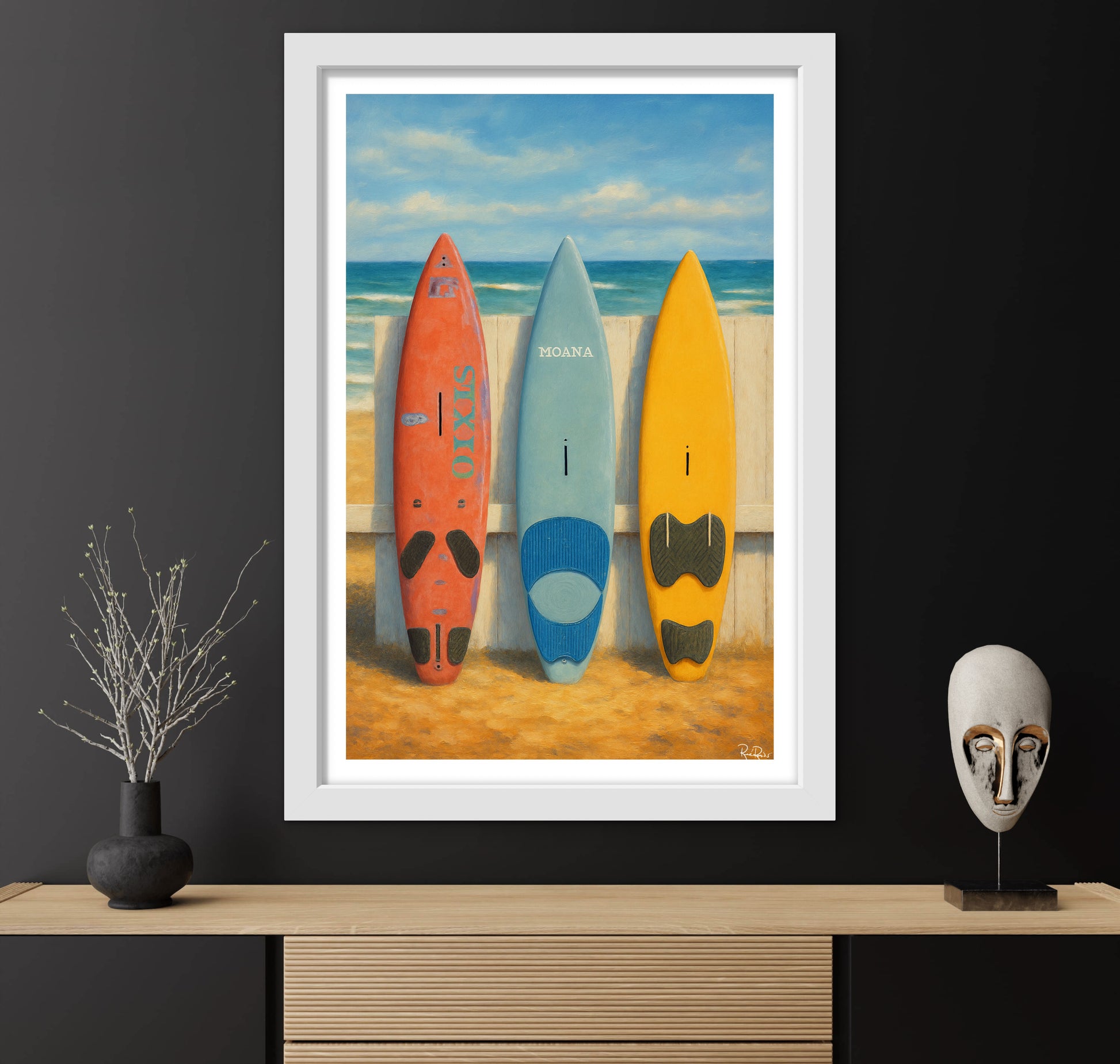 Framed artwork of three surfboards on a beach with decorative items on a shelf below.