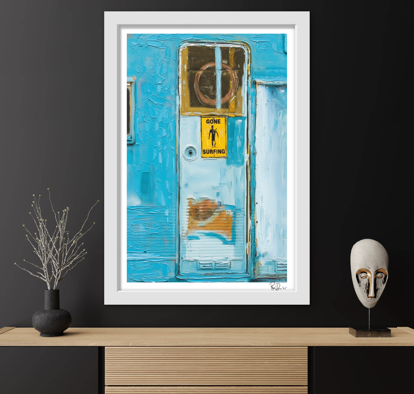 Framed artwork of a blue door with a 'Gone Surfing' sign on a black wall.