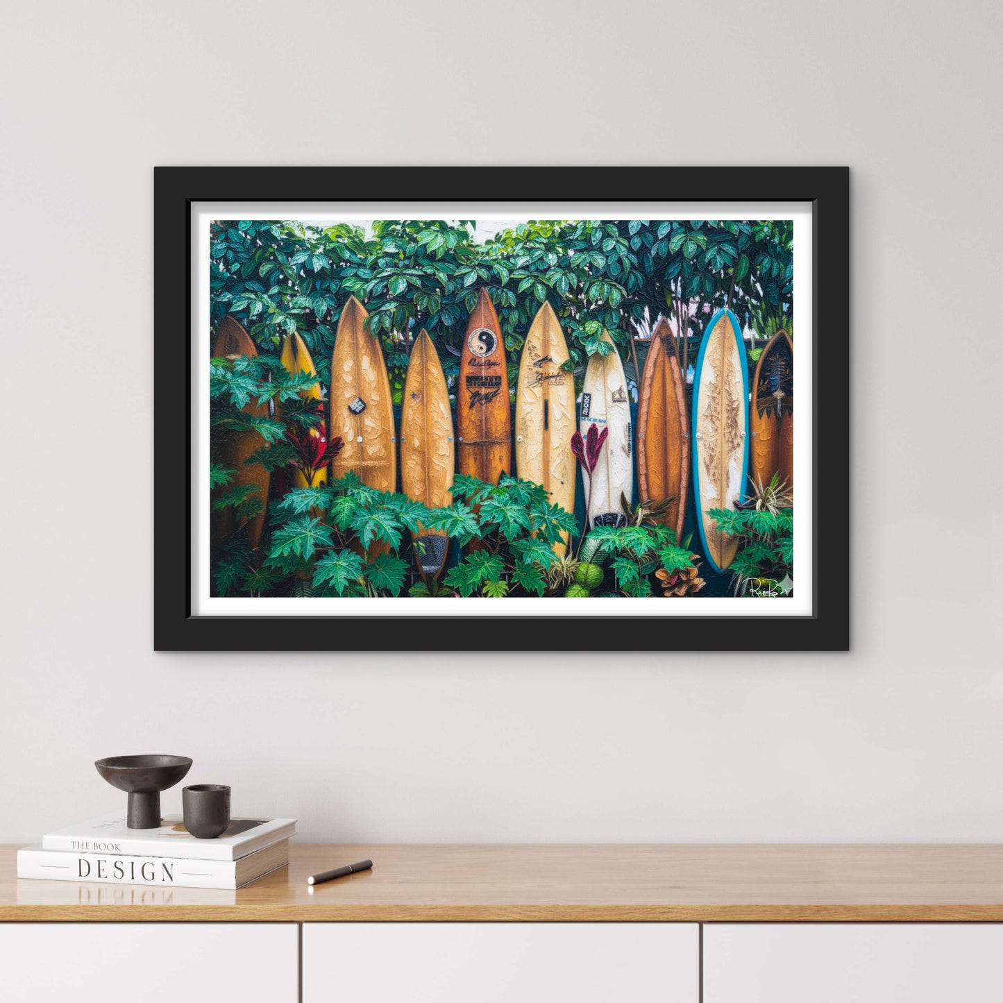 Framed artwork of surfboards among plants on a wall above a wooden shelf.