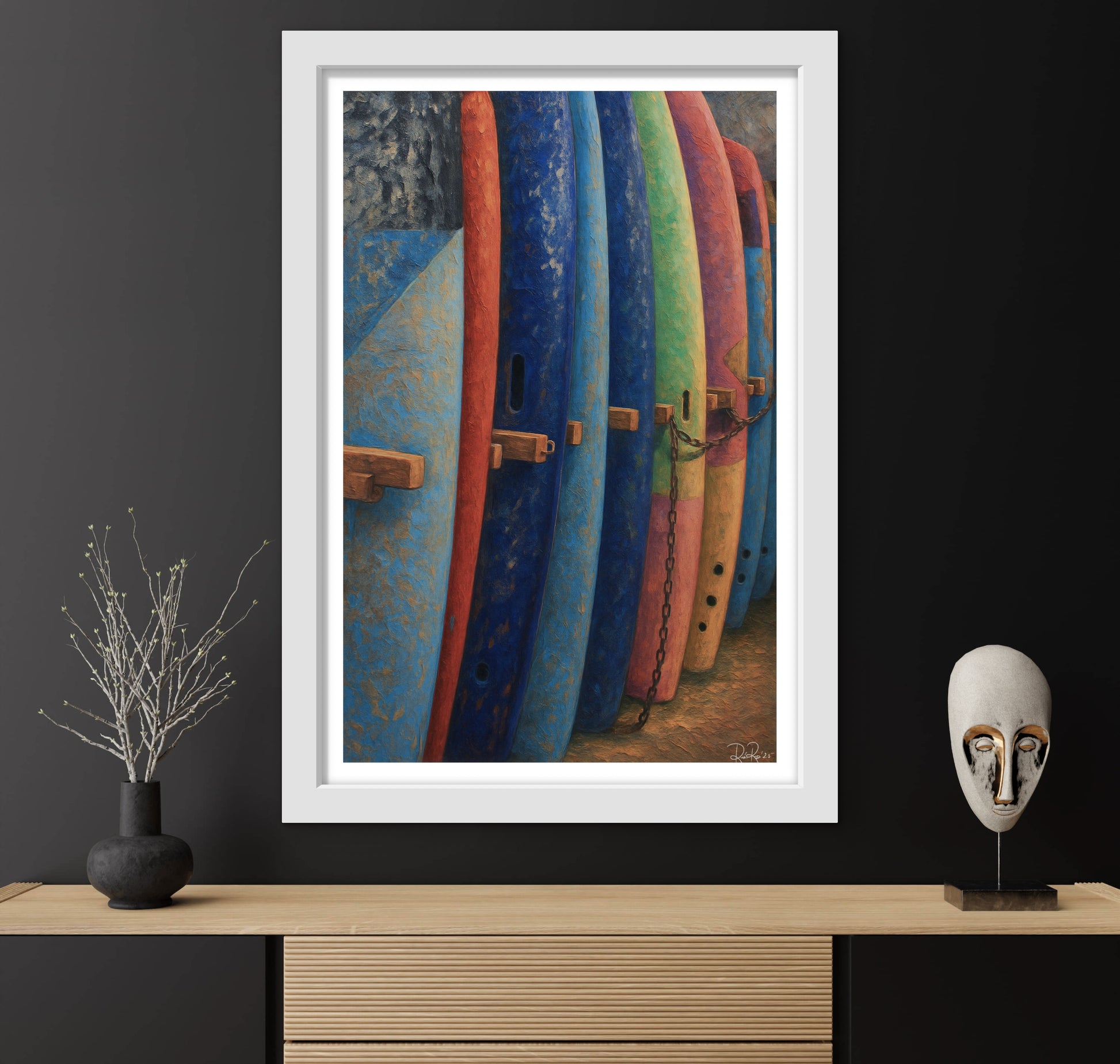 Framed artwork of colorful surfboards on a dark wall with decorative items below.