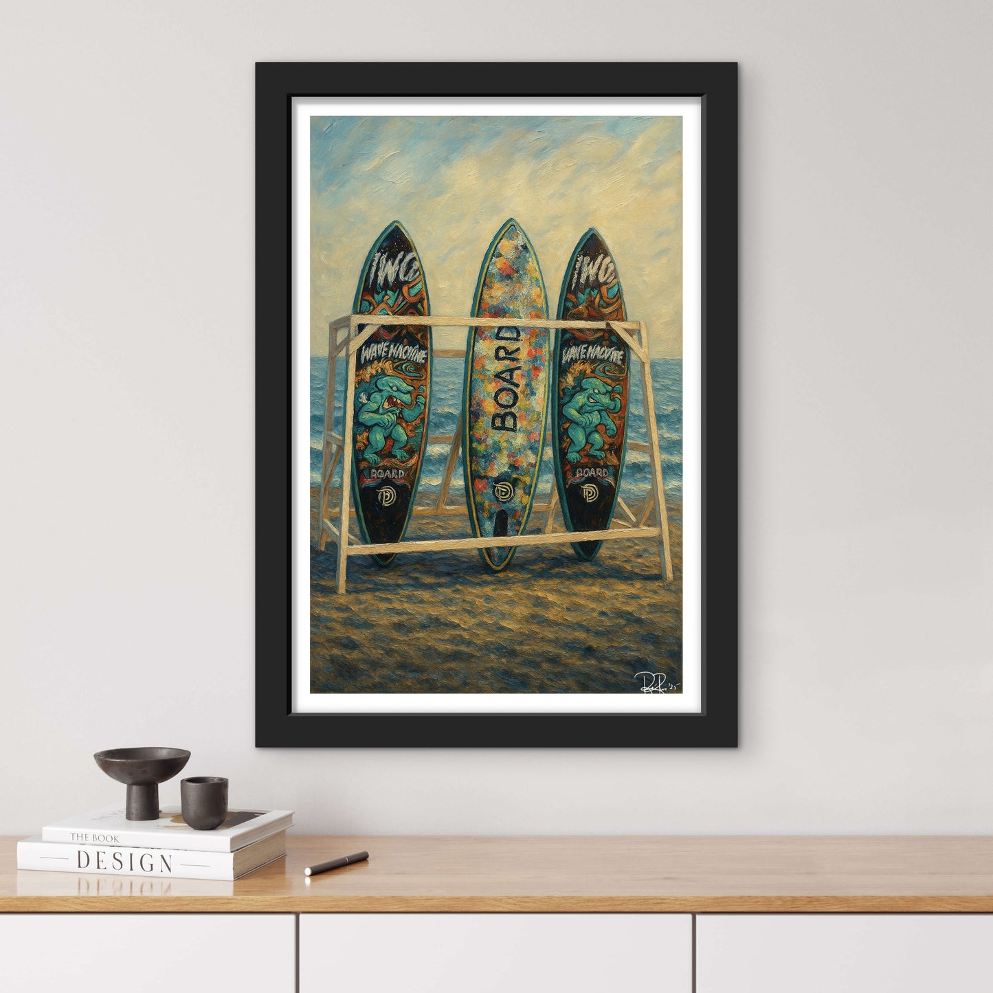Framed artwork of surfboards on a beach with a black frame.
