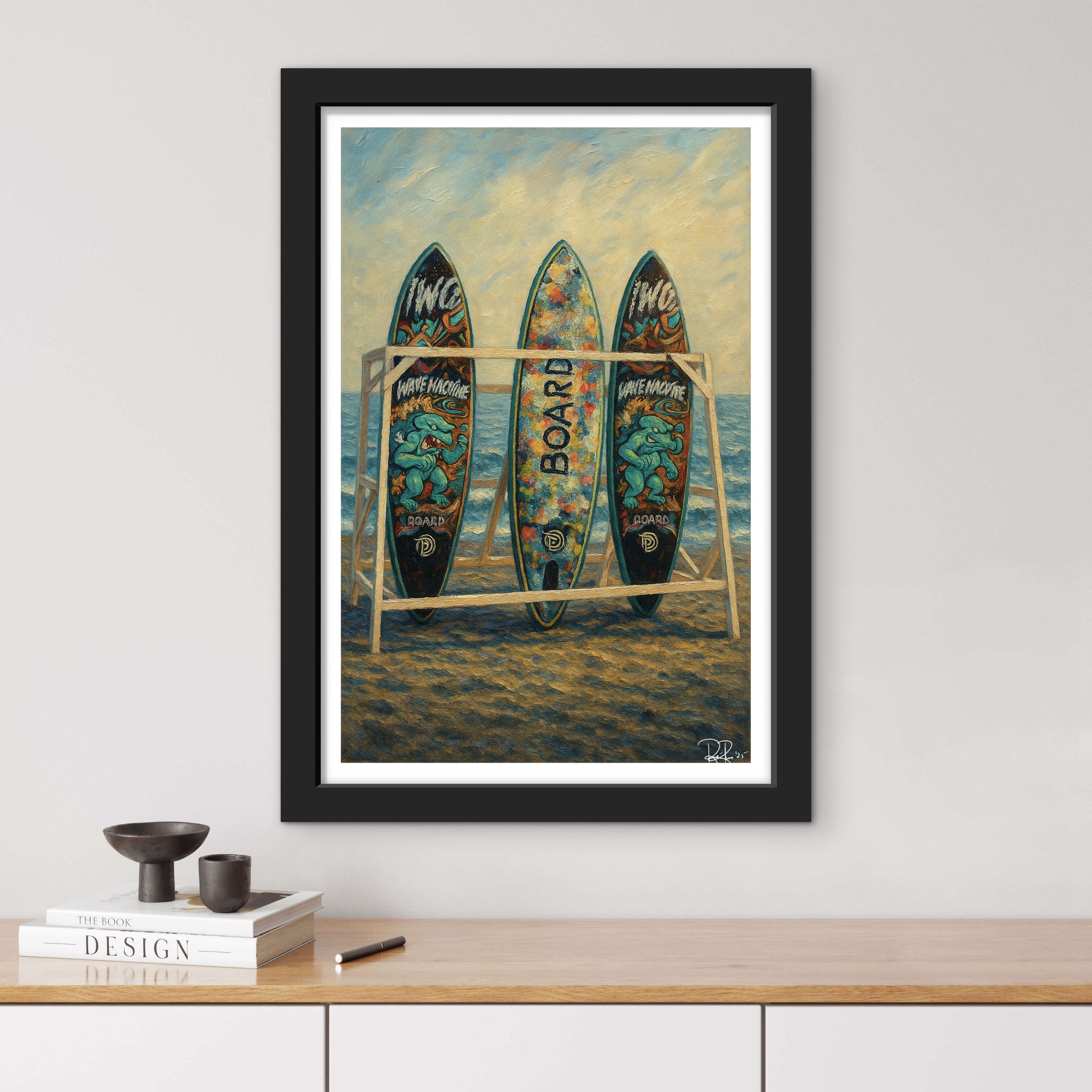 Framed artwork of surfboards on a beach with a black frame.