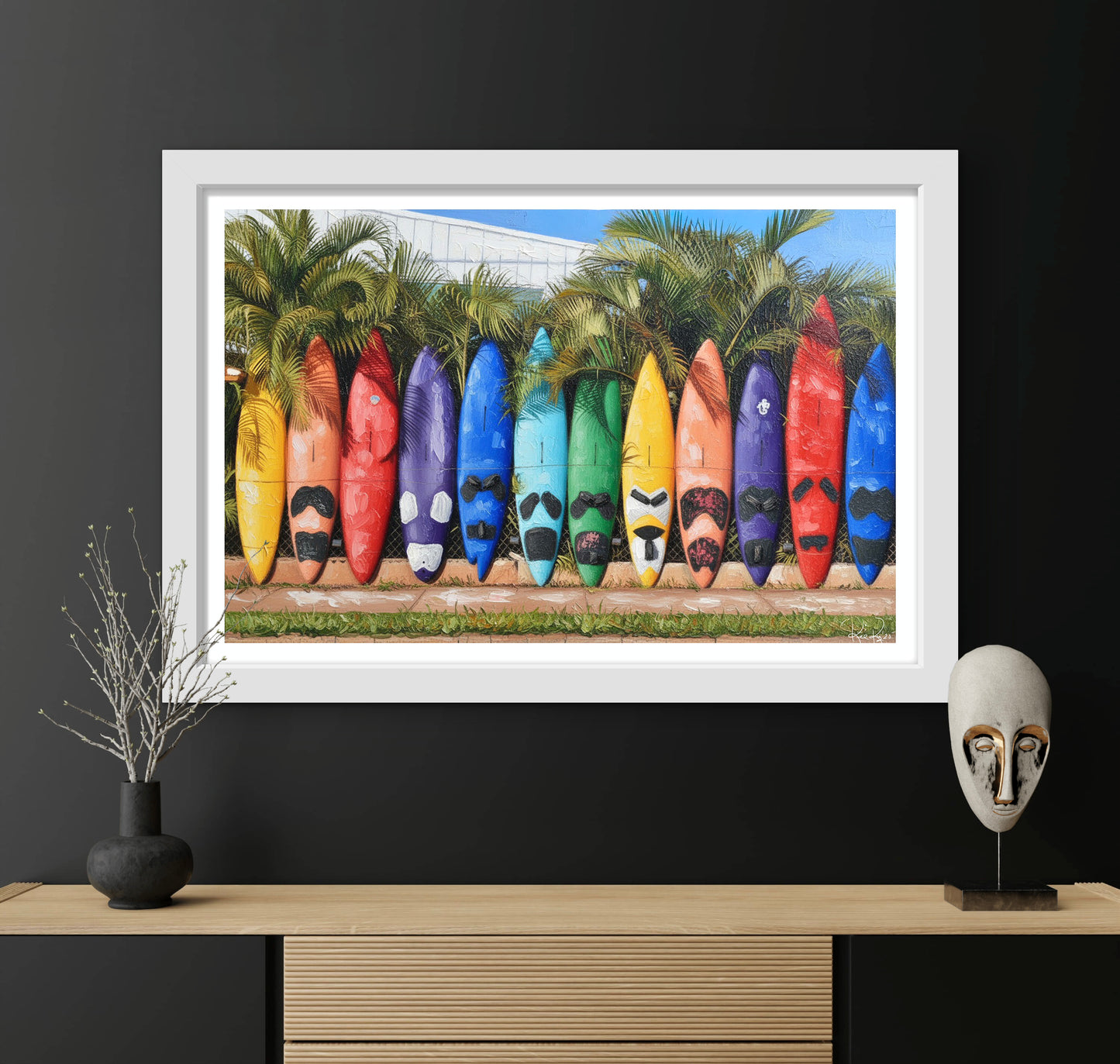 Framed artwork of colorful surfboards against a palm tree background on a black wall.