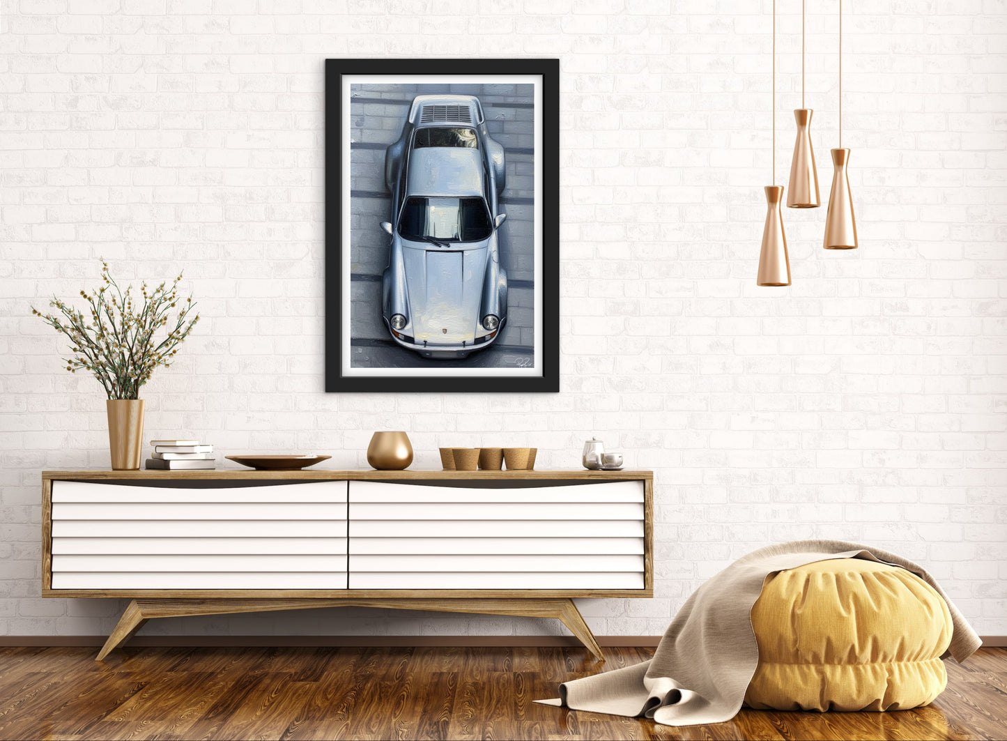 Framed picture of a car on a wall above a wooden console table with decorative items.