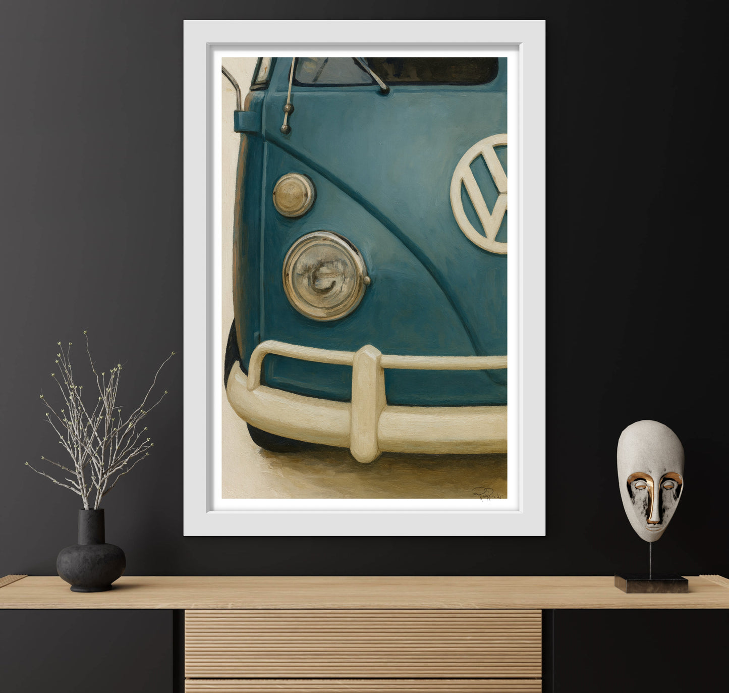 Framed artwork of a vintage Volkswagen van on a dark wall with decorative items.