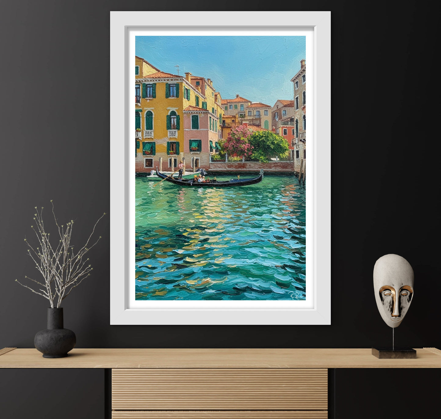 Framed painting of a canal scene with buildings and a gondola, displayed on a wall with decorative items.