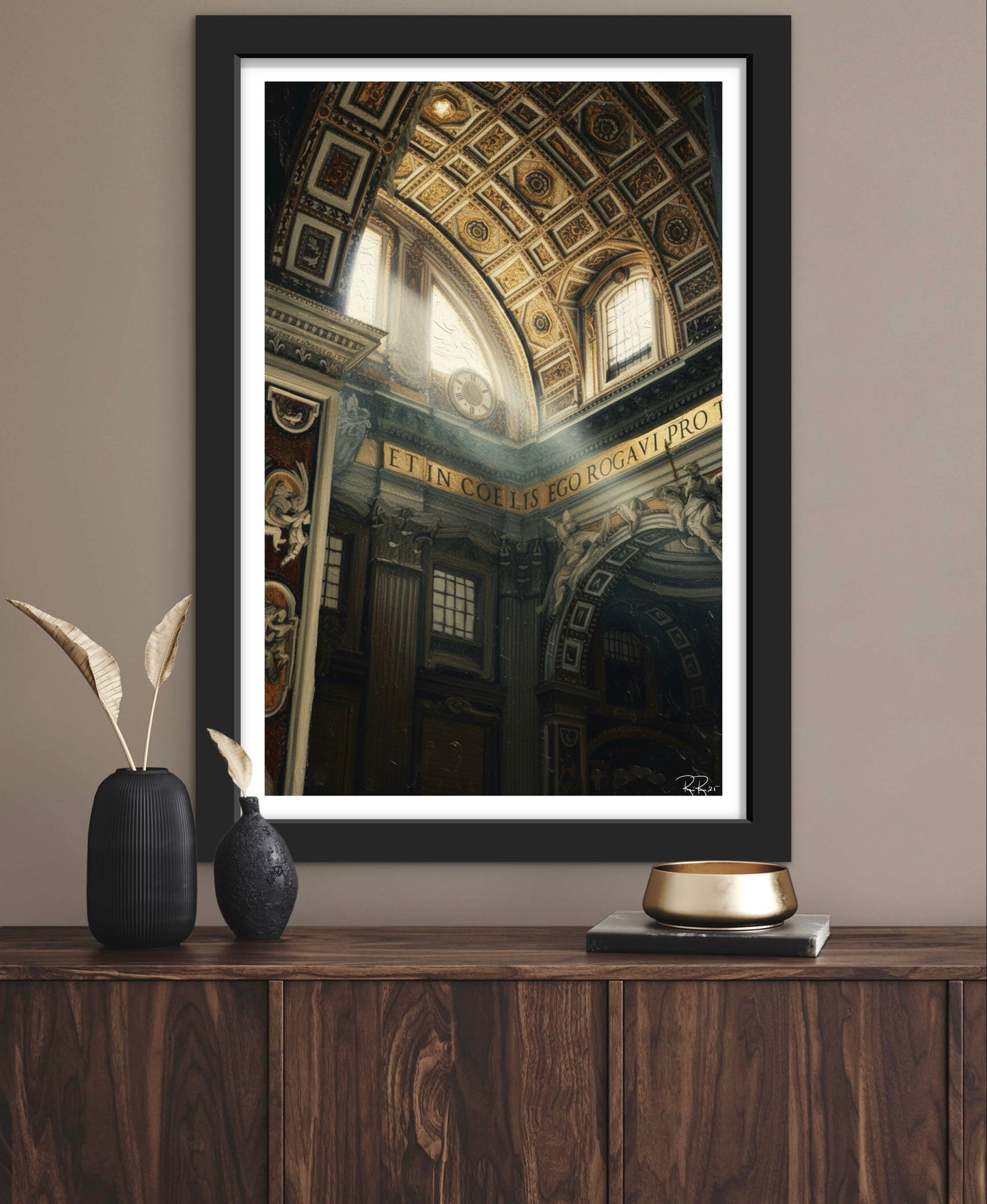 Framed artwork of a classical interior on a wall above a wooden console table.