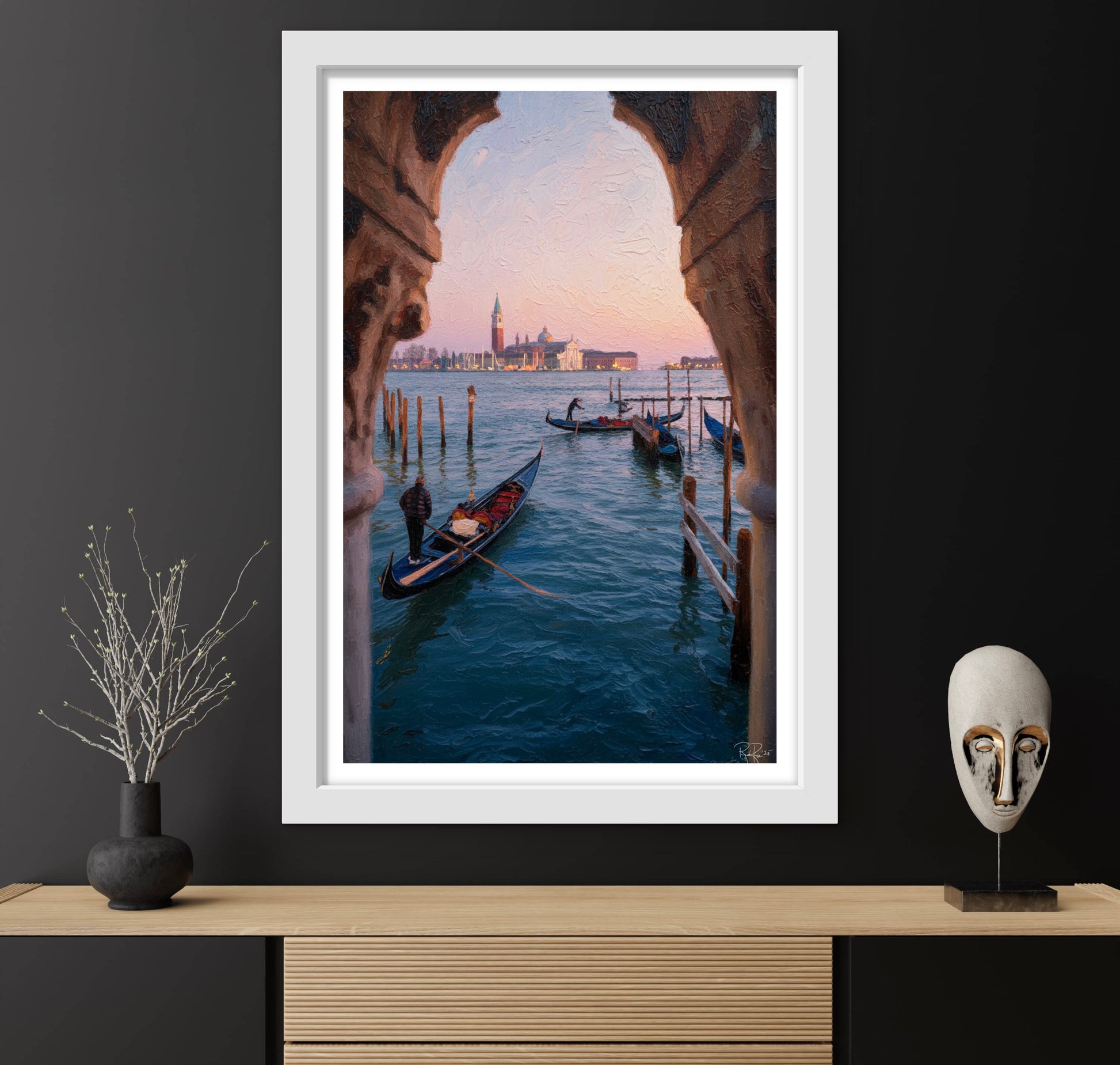 Framed photograph of a Venetian canal with gondolas and a cityscape, displayed on a dark wall with decorative items.
