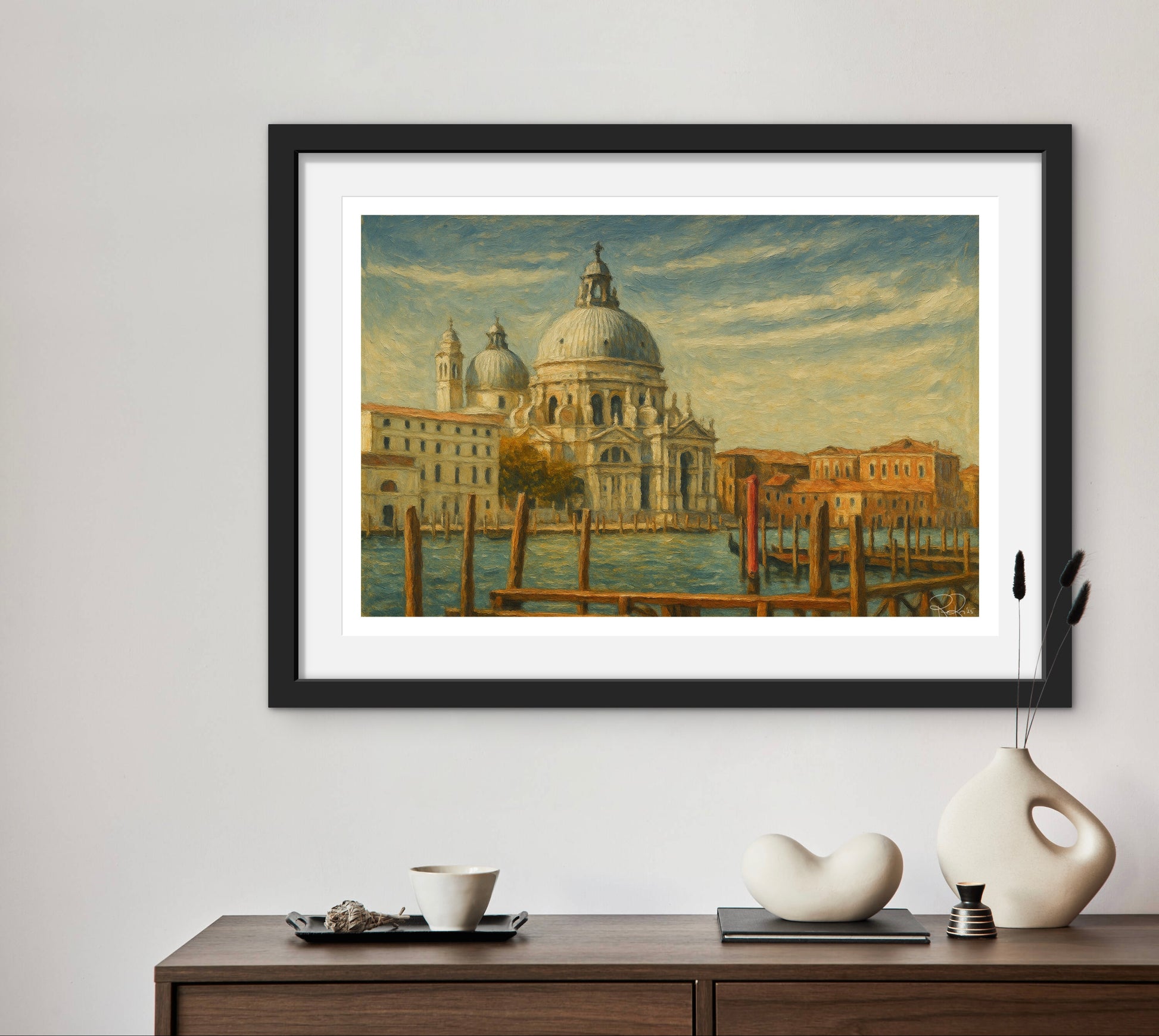Framed artwork of a cityscape with a dome on a wall above a wooden console table.