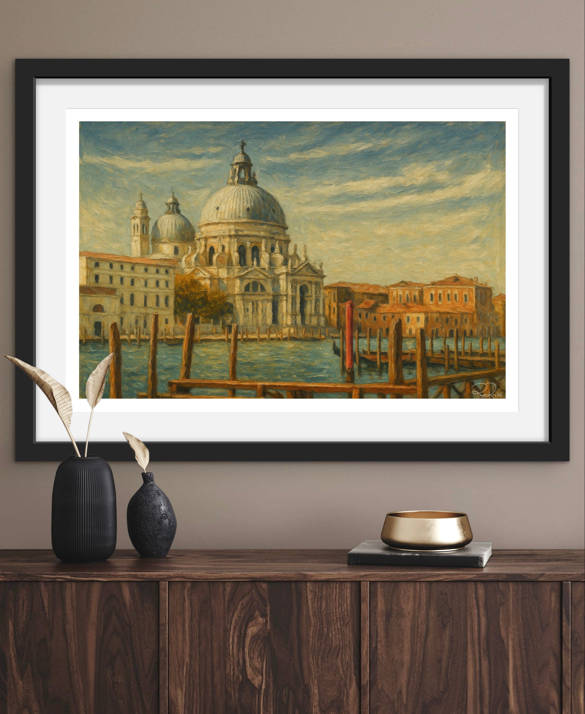 Framed painting of a cityscape with a large building on a waterway, displayed on a wooden surface.