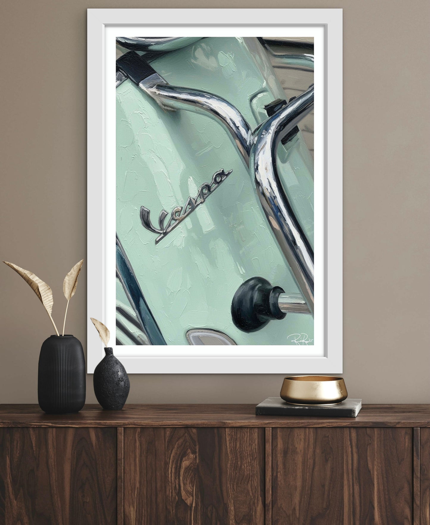 Framed artwork of a Vespa scooter on a wooden surface with decorative items.