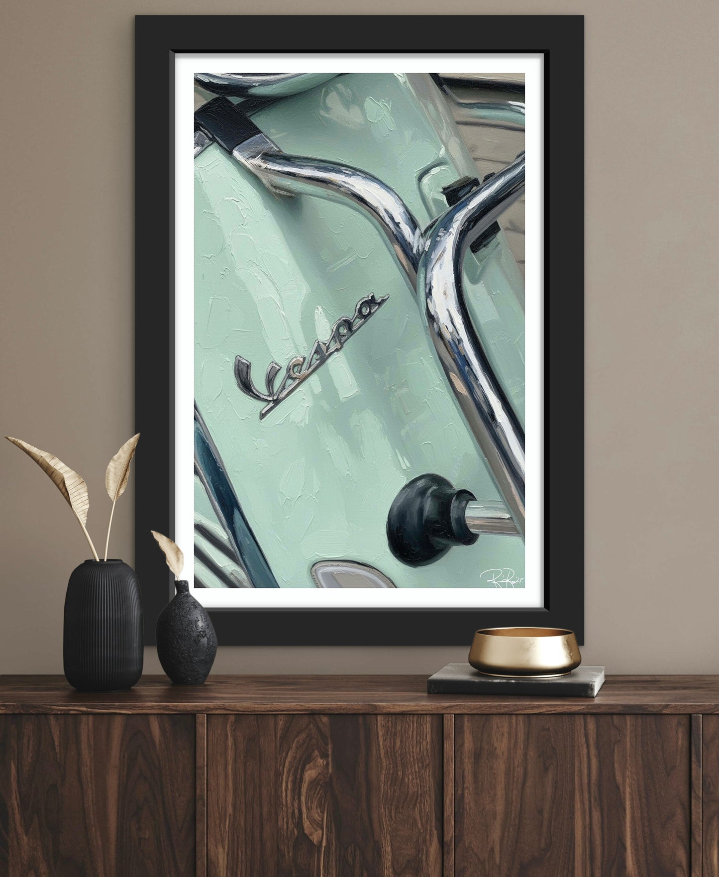 Framed picture of a Vespa on a wooden surface with decorative items.