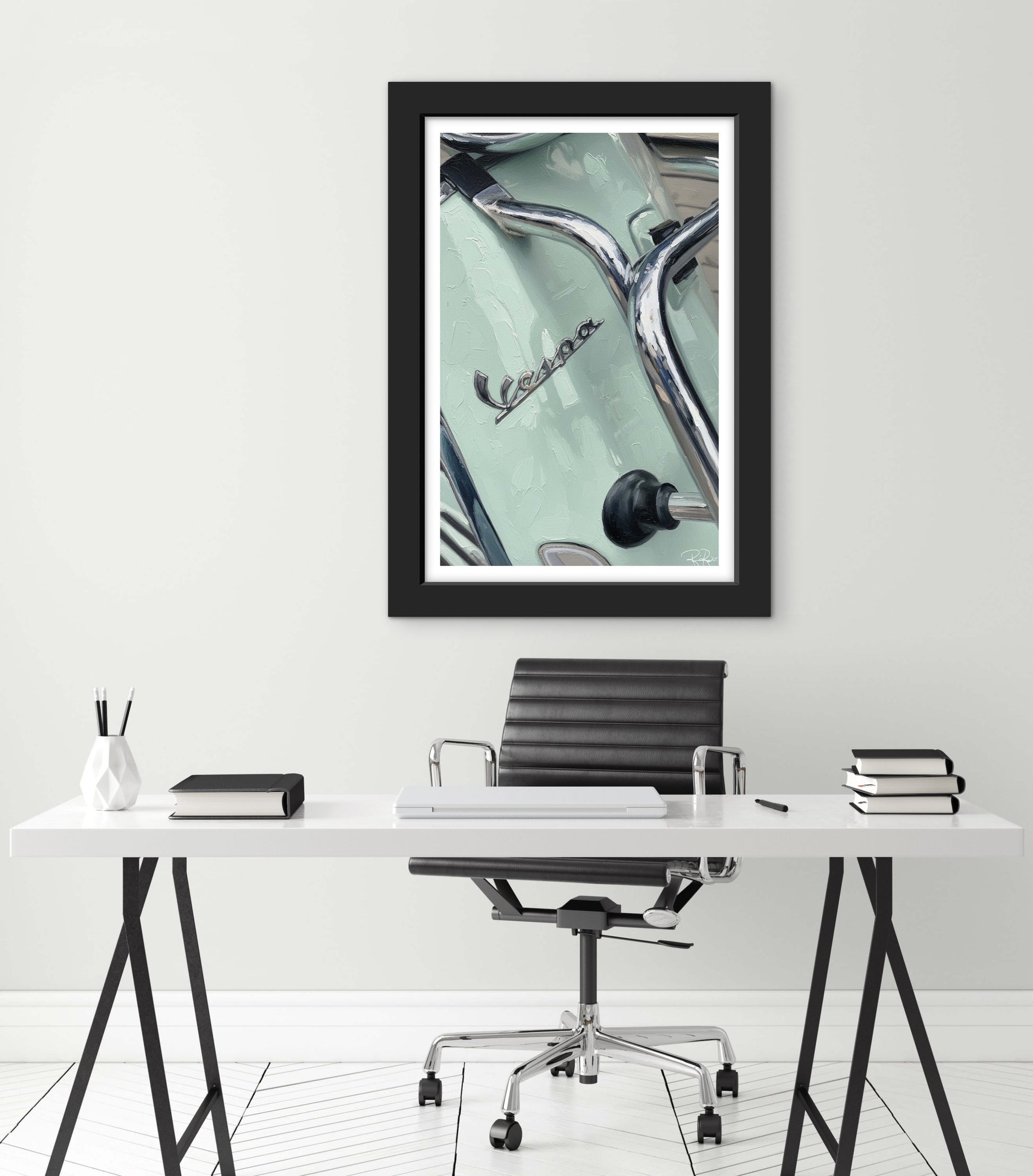 Framed artwork of a vintage car on a wall above a desk.