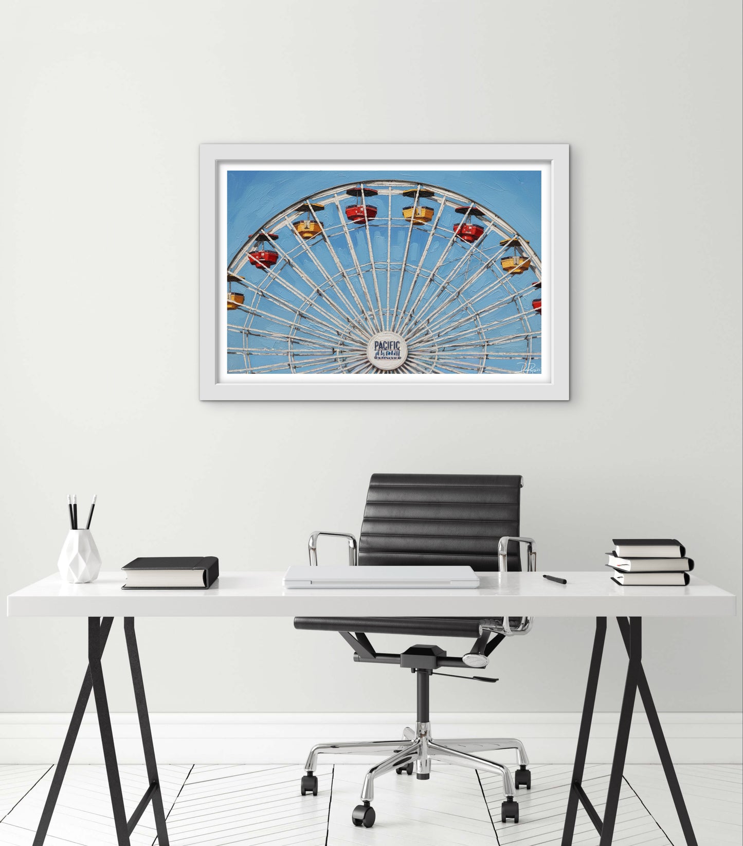 Framed picture of a Ferris wheel above a desk with office furniture.