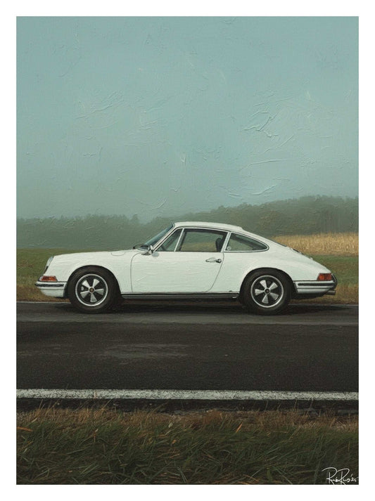 White vintage car on a road with a misty landscape